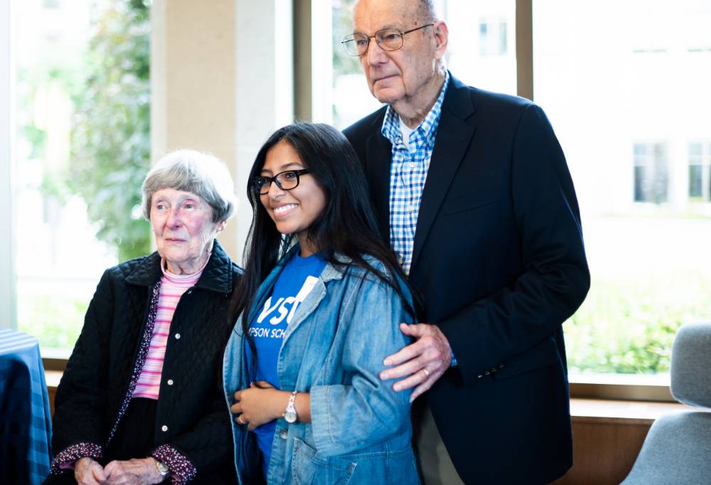 A Thompson Scholar standing with Robert and Ellen Thompson.